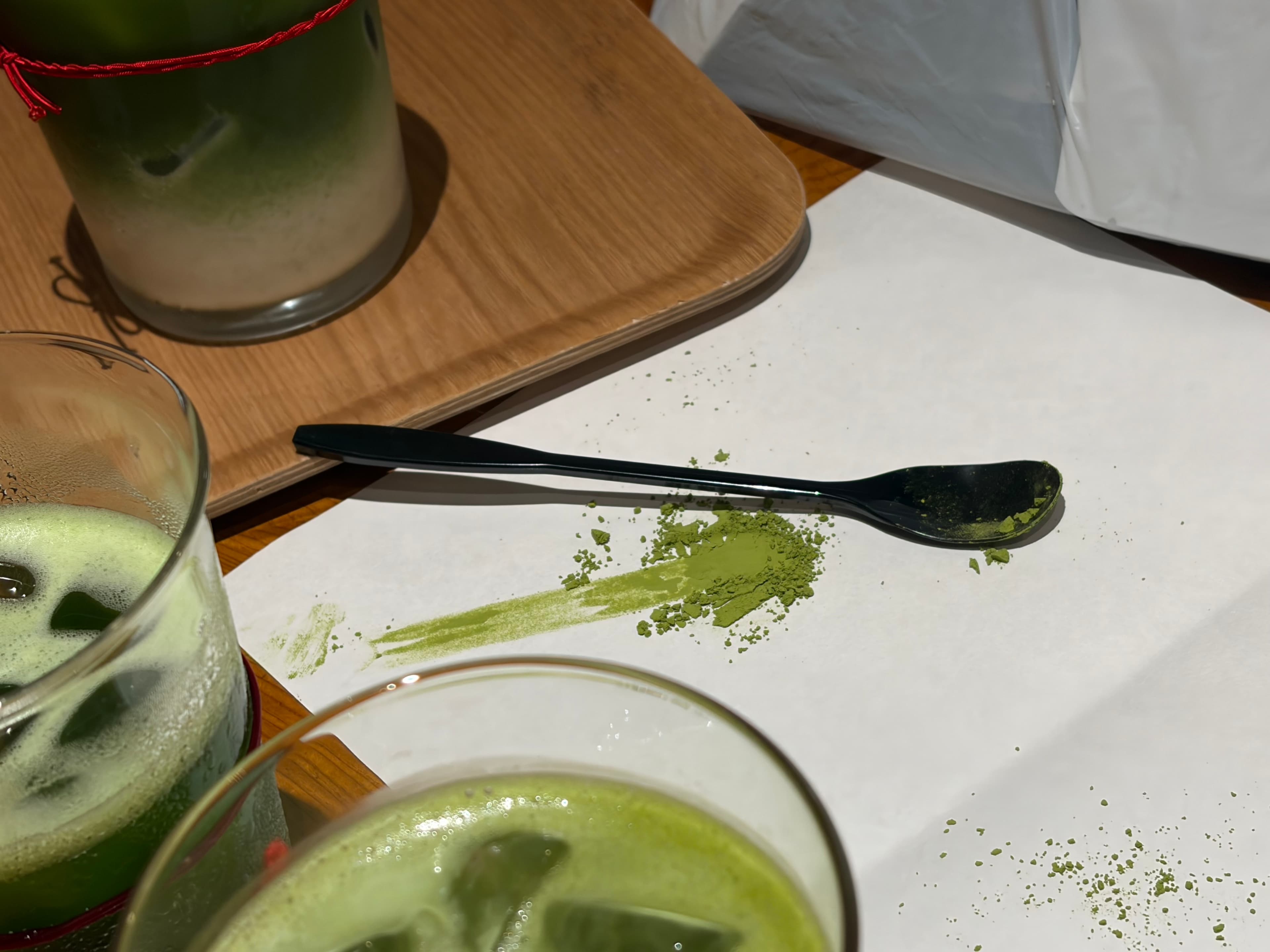 Iced matcha lattes on a wooden counter